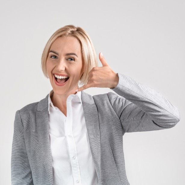 אישה מחייכת מזמינה אותך להתקשר אלינו לטיפול שיניים בהרדמה או סדציה