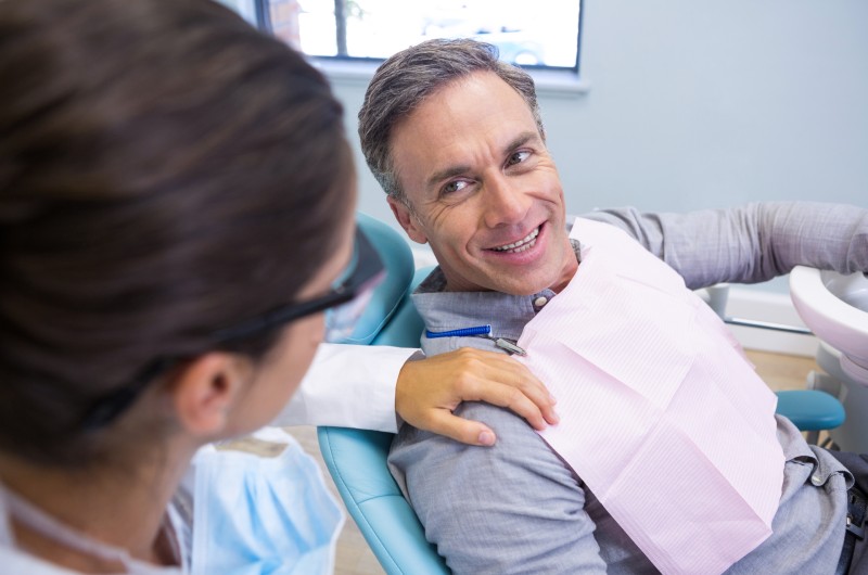 patient-looking-at-dentist-while-sitting-on-chair