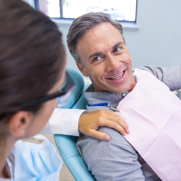 patient-looking-at-dentist-while-sitting-on-chair